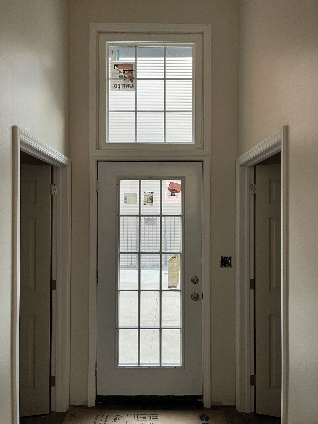 Tall front entrance with an upper clerestory window and fitted casing