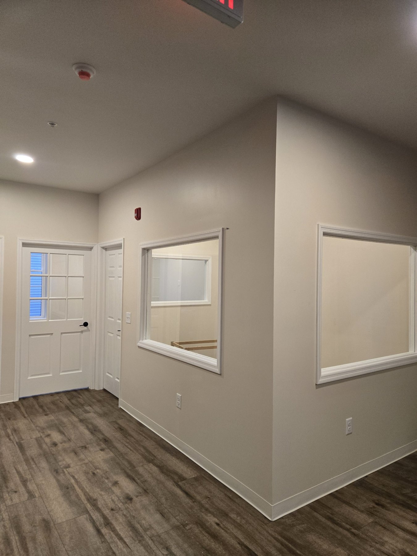 Finished interior openings with white casing and a paneled door