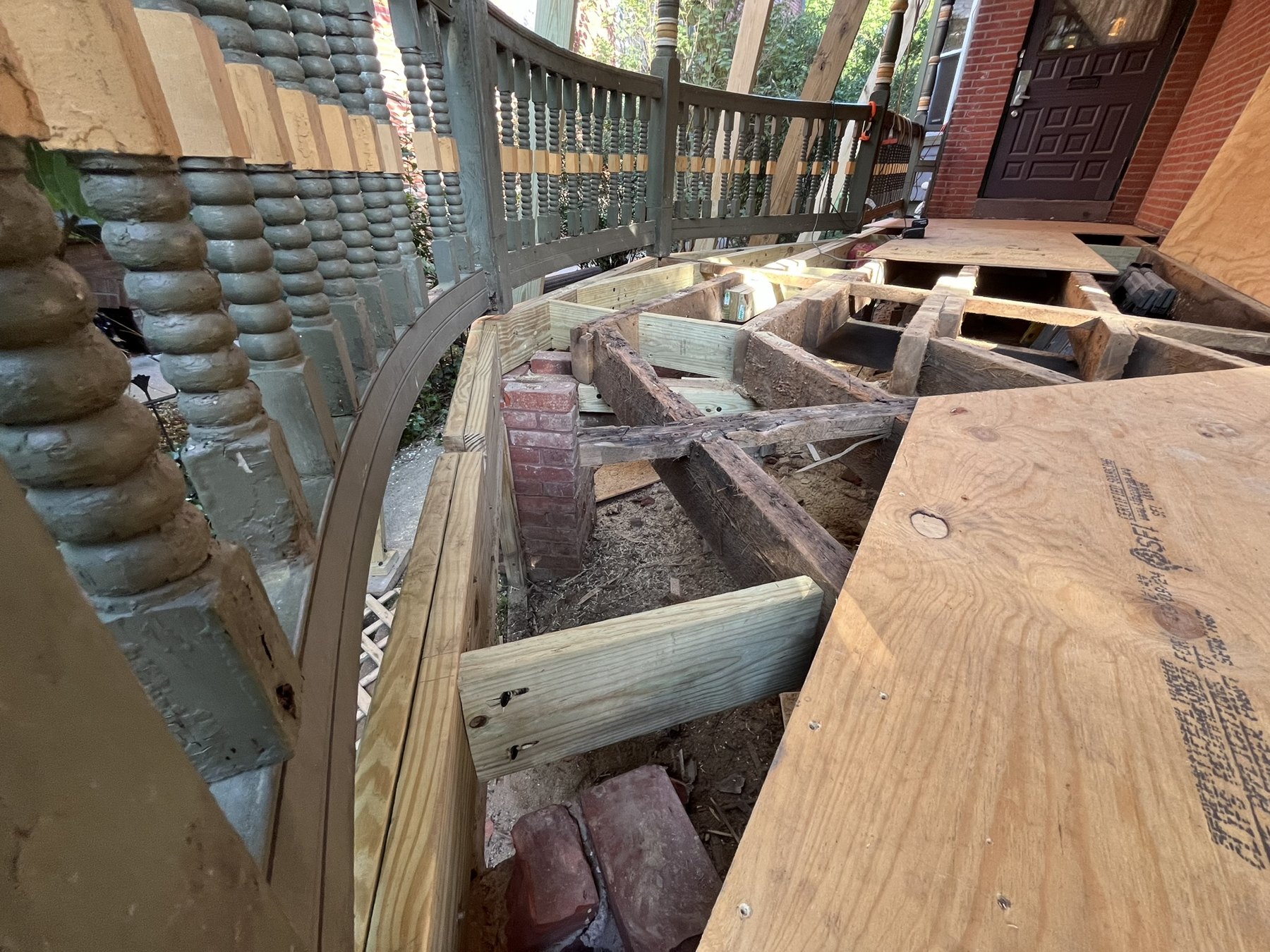 Exposed porch framing beside retained turned railing