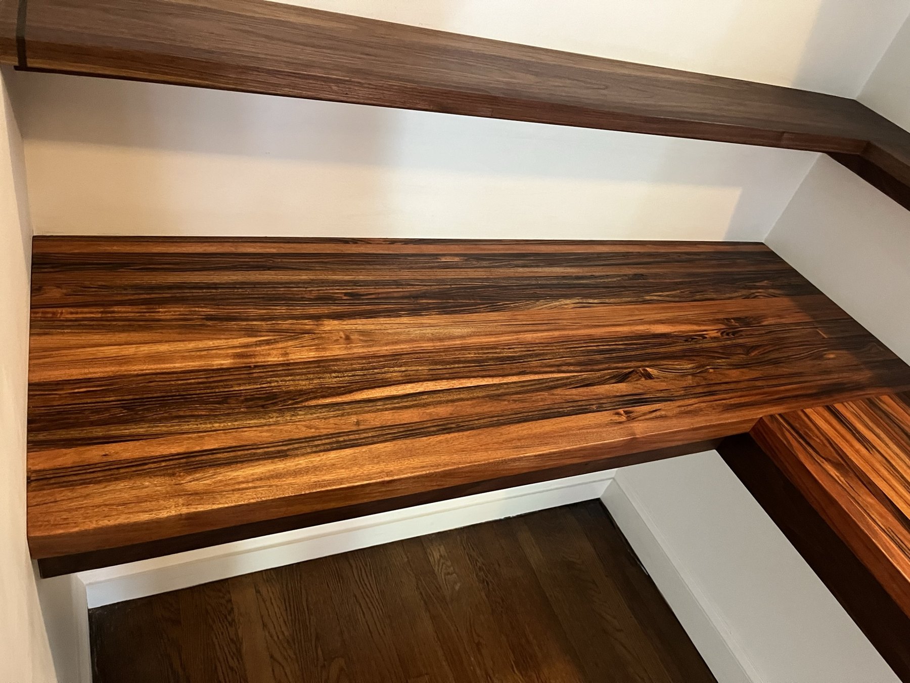 Curupay counter beneath walnut pantry shelves