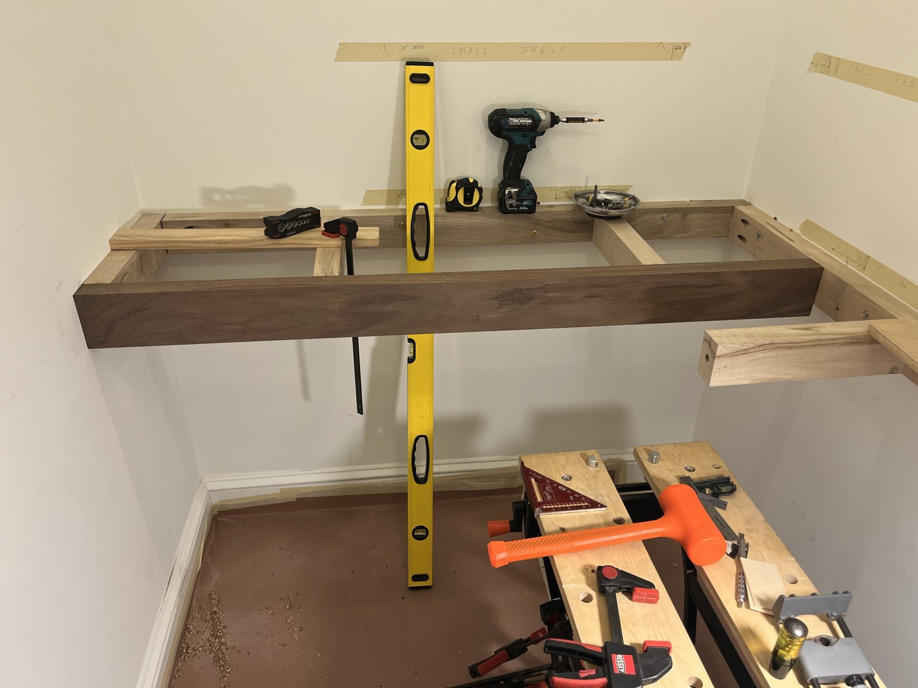 Wood supports and walnut front member during pantry installation