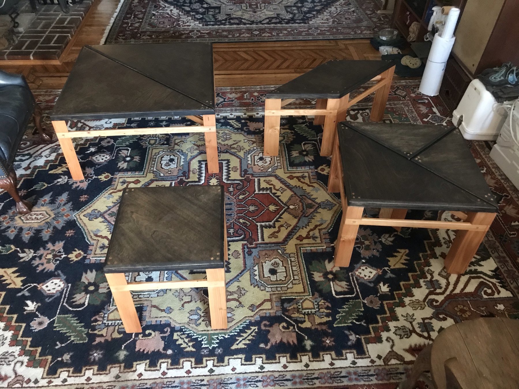 Finished geometric tangram tables assembled into a larger surface
